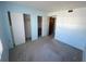 Empty bedroom with light blue walls, grey carpet, and double closets at 2227 Sunset Dr # E-22, Bradenton, FL 34207