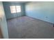 Spacious bedroom with light blue walls and gray carpeting at 2227 Sunset Dr # E-22, Bradenton, FL 34207