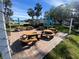 Brick paved patio with multiple picnic tables and umbrellas at 2227 Sunset Dr # E-22, Bradenton, FL 34207