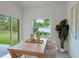 Light and airy dining room with a wooden table, sliding glass doors and neutral decor at 2842 Escambia Cir, North Port, FL 34288