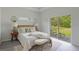 Main bedroom with sliding glass doors, neutral color palette and en-suite bathroom at 2842 Escambia Cir, North Port, FL 34288