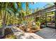 A pathway leads to a screened enclosure near the pool and lush tropical landscaping at 3901 Balsam Ct, Sarasota, FL 34243