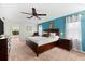 King-size bed in a well-lit main bedroom with access to an ensuite bathroom at 3901 Balsam Ct, Sarasota, FL 34243