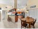 Open concept kitchen with breakfast nook, island and wood cabinets at 3901 Balsam Ct, Sarasota, FL 34243