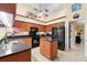 Modern kitchen with wood cabinets, granite countertops, and island at 3901 Balsam Ct, Sarasota, FL 34243