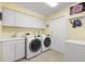 Laundry room with washer, dryer, and extra storage at 3901 Balsam Ct, Sarasota, FL 34243