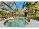 Enjoy this screened pool and spa area with lush landscaping at 3901 Balsam Ct, Sarasota, FL 34243