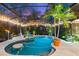 Inviting pool and spa area with night lighting and lush landscaping at 3901 Balsam Ct, Sarasota, FL 34243