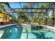 Spacious pool and spa with a screened enclosure and lush landscaping at 3901 Balsam Ct, Sarasota, FL 34243