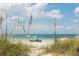 Relaxing beach view with umbrella-shaded seating at 5392 Gulf Dr, Holmes Beach, FL 34217