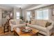 Spacious living room with beige sofas and a wooden coffee table at 5392 Gulf Dr, Holmes Beach, FL 34217