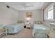 Well-lit guest bedroom with twin beds and dresser at 5420 Swift Rd # 38, Sarasota, FL 34231