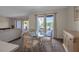 Bright dining room with glass table and wicker chairs, adjacent to kitchen at 5420 Swift Rd # 38, Sarasota, FL 34231