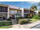 Two-story condo building with balconies, landscaping, and parking at 5420 Swift Rd # 38, Sarasota, FL 34231