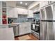 Modern kitchen with white cabinets, stainless steel appliances, and island at 5420 Swift Rd # 38, Sarasota, FL 34231