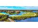 Aerial view of golf course community with waterfront homes and canals at 608 Misty Pond Ct, Bradenton, FL 34212