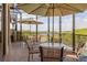 Scenic patio with tables, umbrellas, and water views at 608 Misty Pond Ct, Bradenton, FL 34212