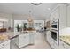 White kitchen with stainless steel appliances and granite countertops at 608 Misty Pond Ct, Bradenton, FL 34212