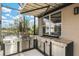 Modern outdoor kitchen with stainless steel appliances, perfect for entertaining at 608 Misty Pond Ct, Bradenton, FL 34212