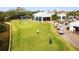 Putting green with golfers and clubhouse in the background at 608 Misty Pond Ct, Bradenton, FL 34212