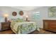 Guest bedroom with a comfortable bed and tropical bedding at 6440 Mourning Dove Dr # 403, Bradenton, FL 34210