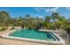 Inviting community pool with spa and lounge chairs at 6440 Mourning Dove Dr # 403, Bradenton, FL 34210