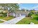 Updated ranch home with gray roof and spacious driveway at 6609 Waterford Ln, Sarasota, FL 34238