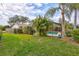 Backyard oasis featuring a refreshing pool and lush landscaping at 6609 Waterford Ln, Sarasota, FL 34238