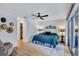 Bright bedroom with teal bedding, hardwood floors, ceiling fan, and a large closet at 6609 Waterford Ln, Sarasota, FL 34238