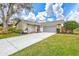 Mid-century modern home with gray exterior and landscaped yard at 6609 Waterford Ln, Sarasota, FL 34238