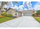 Mid-century modern home with gray exterior and landscaped yard at 6609 Waterford Ln, Sarasota, FL 34238