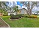 Landscaped front yard with mature trees and well-manicured lawn at 6609 Waterford Ln, Sarasota, FL 34238