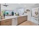 Modern kitchen with wood cabinets, white countertops, and stainless steel appliances at 6609 Waterford Ln, Sarasota, FL 34238