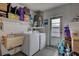 Convenient laundry room with washer, dryer, utility sink, and storage at 6609 Waterford Ln, Sarasota, FL 34238