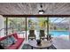 Covered patio overlooking the pool with seating and ceiling fan at 6609 Waterford Ln, Sarasota, FL 34238