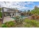 Relaxing poolside patio with lush landscaping and screened enclosure at 6609 Waterford Ln, Sarasota, FL 34238