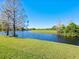 Scenic backyard view featuring a tranquil pond and lush greenery at 7123 Beechmont Ter, Lakewood Ranch, FL 34202