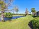 Landscaped backyard with pond and golf course views at 7123 Beechmont Ter, Lakewood Ranch, FL 34202