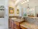 Bathroom with granite countertop, double sinks and large mirror at 7123 Beechmont Ter, Lakewood Ranch, FL 34202