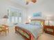 Bright bedroom with a queen-size bed and window shutters at 7123 Beechmont Ter, Lakewood Ranch, FL 34202