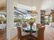 Casual breakfast nook with a glass table and leather chairs, overlooking the pool at 7123 Beechmont Ter, Lakewood Ranch, FL 34202