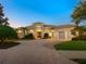 Elegant two-story home with a three-car garage and a brick driveway at 7123 Beechmont Ter, Lakewood Ranch, FL 34202