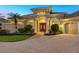 Beautiful home with arched entryway, columned facade, and lush landscaping at 7123 Beechmont Ter, Lakewood Ranch, FL 34202