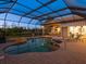 Screened pool and spa with a covered patio and serene view at 7123 Beechmont Ter, Lakewood Ranch, FL 34202