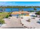 Aerial view of waterfront home with dock and landscaped yard at 725 N Manasota Key Rd # A, Englewood, FL 34223