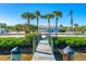 Wooden dock leading to the waterfront with lush greenery at 725 N Manasota Key Rd # A, Englewood, FL 34223