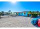 Bright blue house exterior with a large yard and kayaks at 725 N Manasota Key Rd # A, Englewood, FL 34223