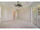 Bright bedroom with neutral walls and carpeting, access to back patio at 15124 Leipzig Cir, Port Charlotte, FL 33981