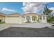 Single-story house with attached garage,light-colored exterior, and landscaped yard at 15124 Leipzig Cir, Port Charlotte, FL 33981