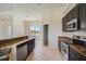 Modern kitchen features granite countertops and dark brown cabinetry at 15124 Leipzig Cir, Port Charlotte, FL 33981